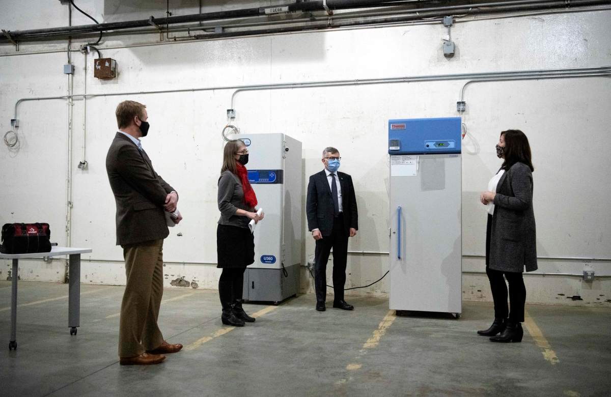 Kari Bergstrom, immunization business manager with Alberta Health, provides logistical highlights of the provincial COVID-19 cold storage vaccine depot to Health Minister Tyler Shandro, Deputy Minister of Health Paul Wynnyk, and Dr. Deena Hinshaw on Monday, December 14, 2020.