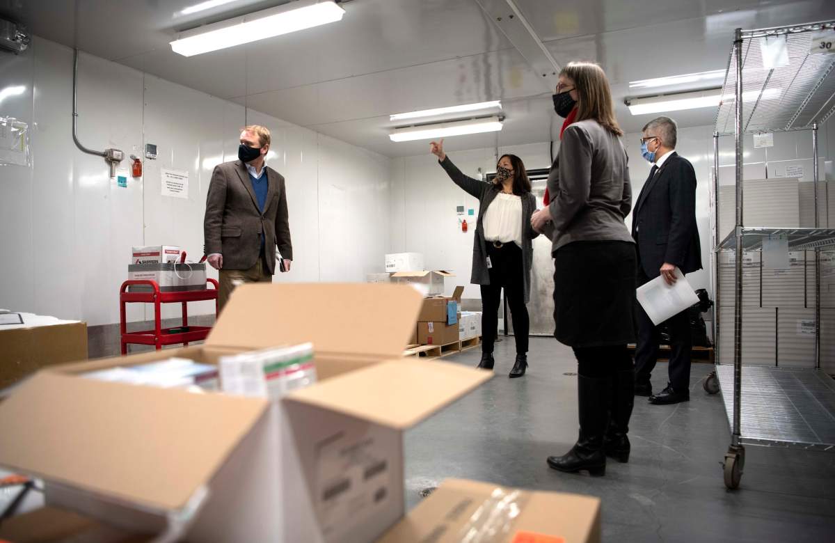 Kari Bergstrom, immunization business manager with Alberta Health, provides logistical highlights of the provincial COVID-19 cold storage vaccine depot to Health Minister Tyler Shandro, Deputy Minister of Health Paul Wynnyk, and Dr. Deena Hinshaw on Monday, December 14, 2020.