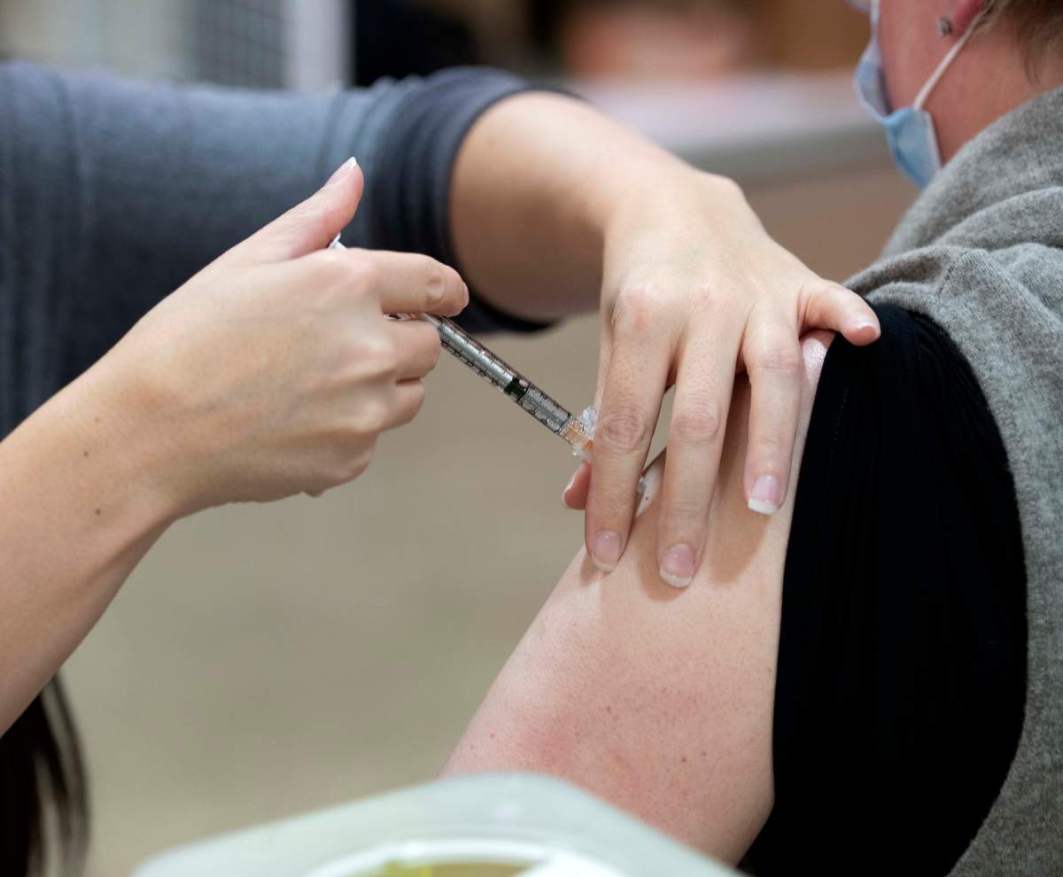 A health-care worker receiving the Pfizer-BioNTech COVID-19 vaccine in Edmonton, Alta. on Tuesday, December 15, 2020.