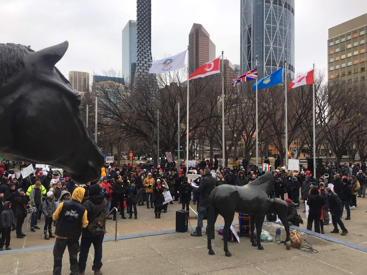 Calgarians gather to protest government restrictions intended to stop the spread of COVID-19, Saturday, Dec. 12, 2020.