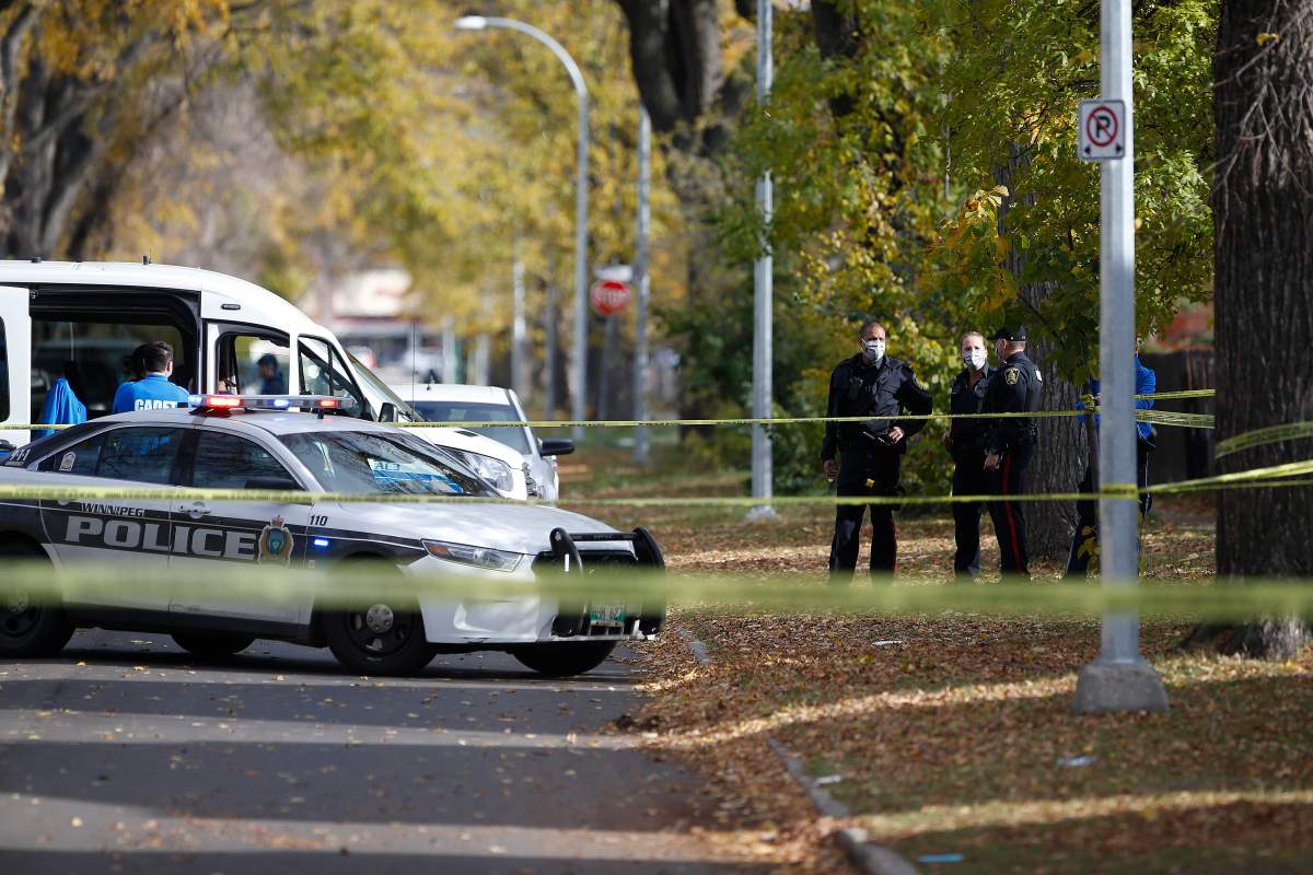 Police investigate at the scene of a police shooting in Winnipeg, Wednesday, Oct. 7, 2020.  
