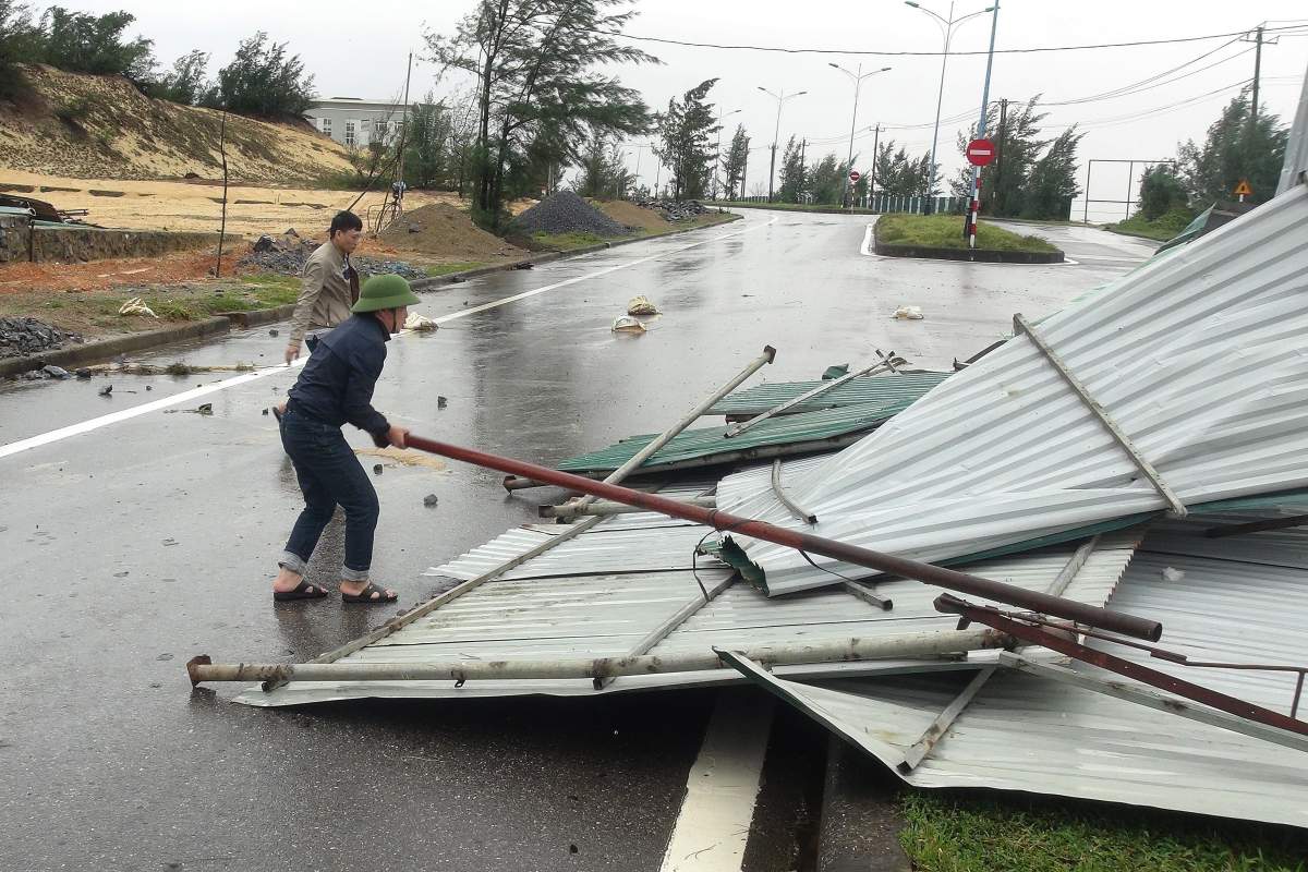 People clean up the street after typhoon Vamco passed, in Quang Binh, Vietnam, 15 November 2020. Typhoon Vamco made landfall in the country's central coast on 15 November 2020.   