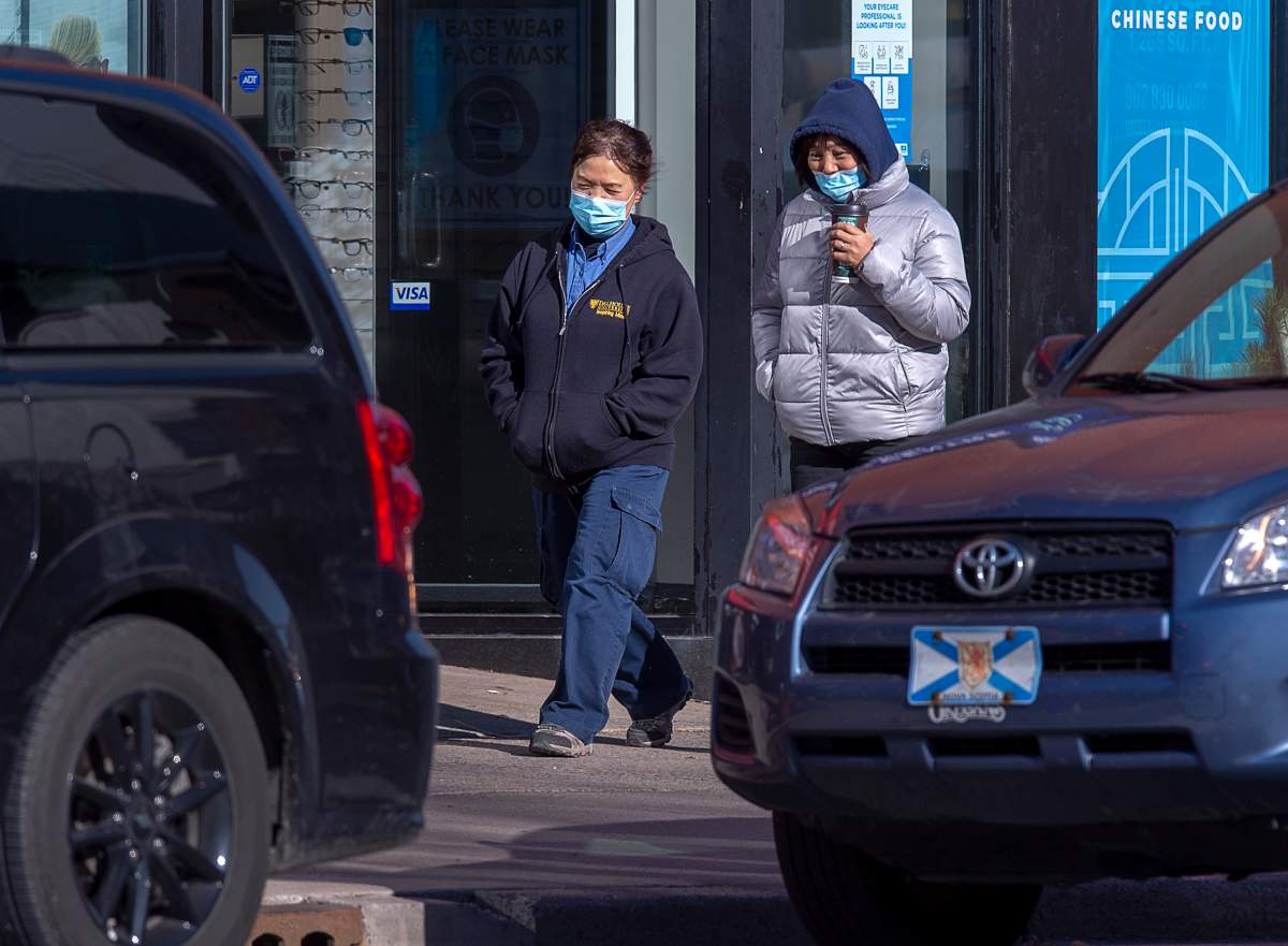 Pedestrians stroll along Spring Garden Road in Halifax on Thursday, Nov. 19, 2020.