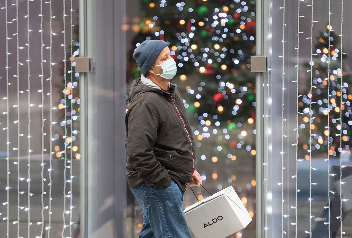 A man walks by festive lights in Montreal, Saturday, Nov. 28, 2020, as the COVID-19 pandemic continues in Canada and around the world. 