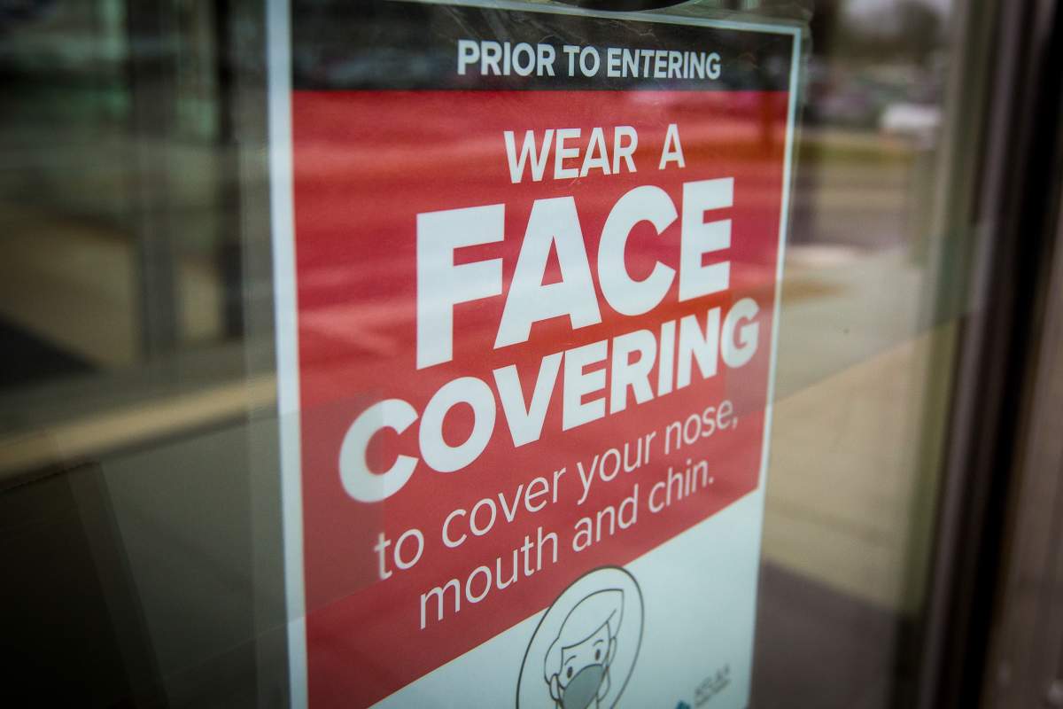A sign advising to wear a face covering at a shopping centre in Kingston, Ont., on Thursday, Dec. 10, 2020, as the COVID-19 pandemic continues across Canada and around the world.