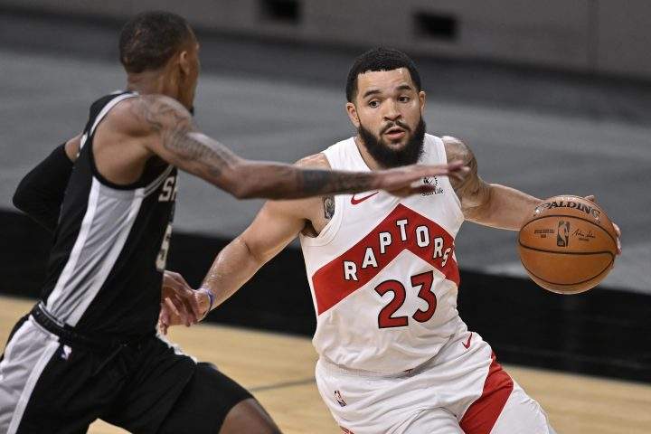 Toronto Raptors' Fred VanVleet (23) drives around San Antonio Spurs' Dejounte Murray during the second half of an NBA basketball game, Saturday, Dec. 26, 2020, in San Antonio. San Antonio won 119-114.