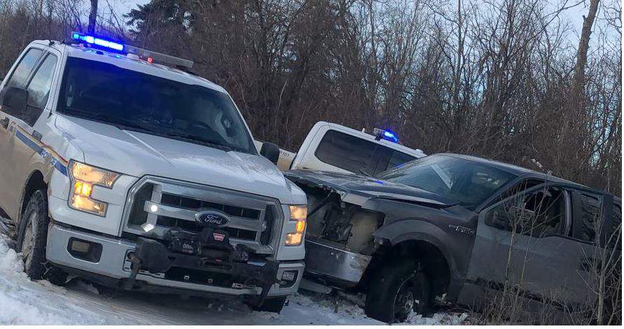 RCMP vehicles box in a truck after a chase started on the Horse Lake First Nation, Alberta on Thursday Dec. 24, 2020. Mounties in Alberta say they've arrested a man with a history of violence against police following a chase where they allege he rammed several police vehicles with his truck. 