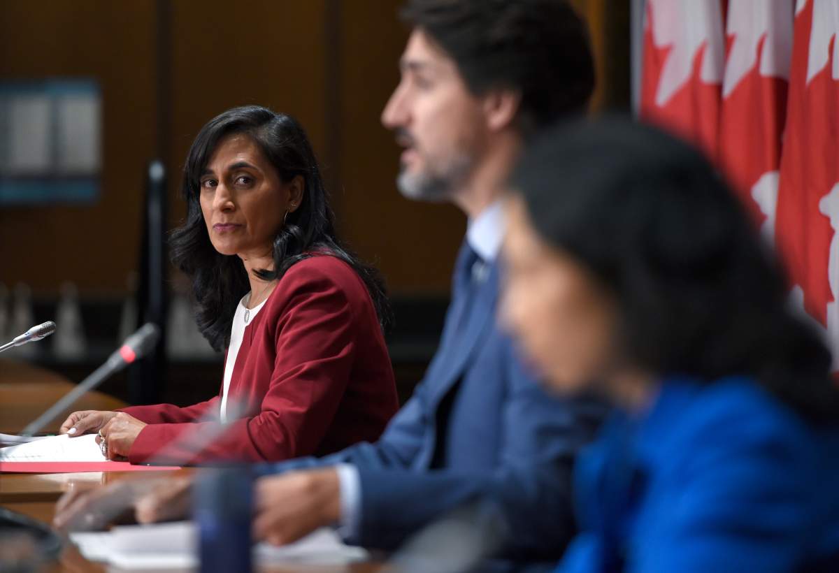 Minister of Public Services and Procurement Anita Anand listens to Prime Minister Justin Trudeau speak during a news conference on the COVID-19 pandemic on Parliament Hill in Ottawa, on Friday, Sept. 25, 2020.