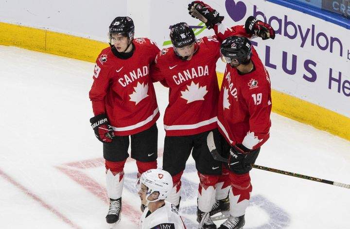 Canada's Jack Quinn (29), Ryan Suzuki (16) and Quinton Byfield (19) celebrate a goal against Switzerland during second period IIHF World Junior Hockey Championship action in Edmonton on Tuesday, December 29, 2020. 