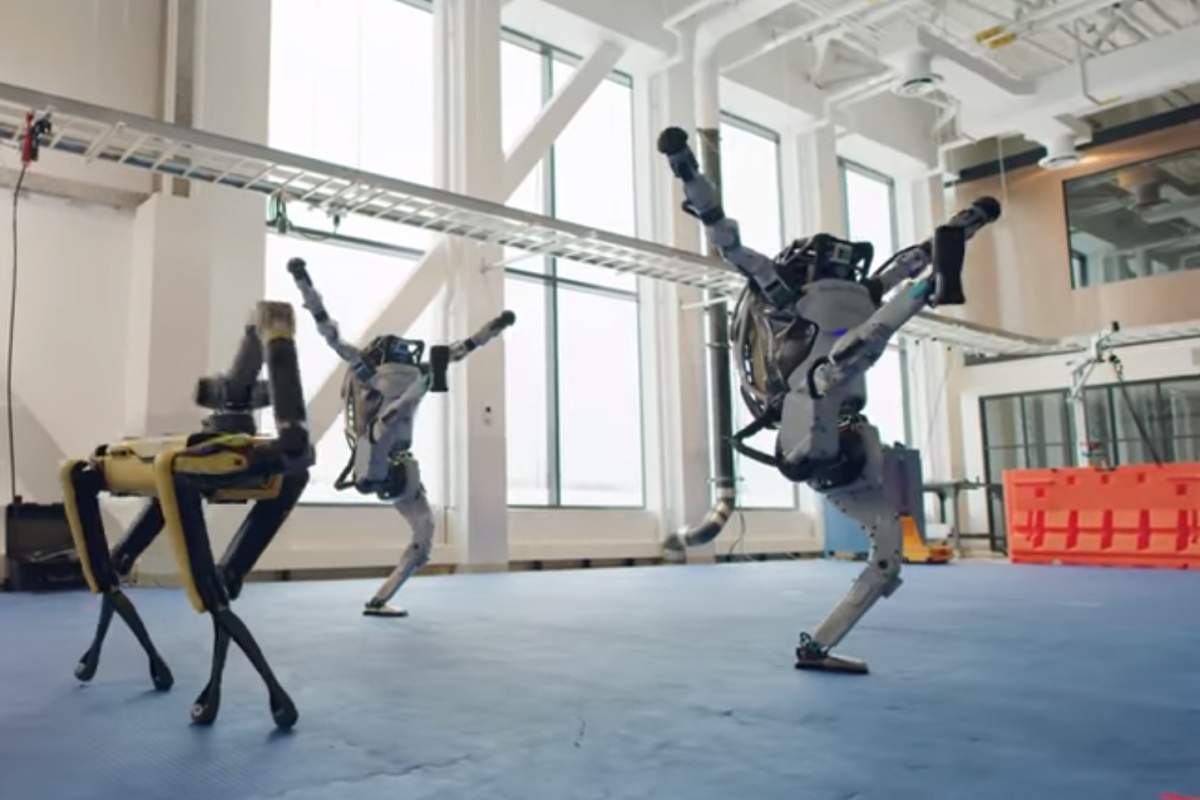 Two Atlas robots and a Spot dance at a Boston Dynamics facility in this image from video released Dec. 29, 2020.