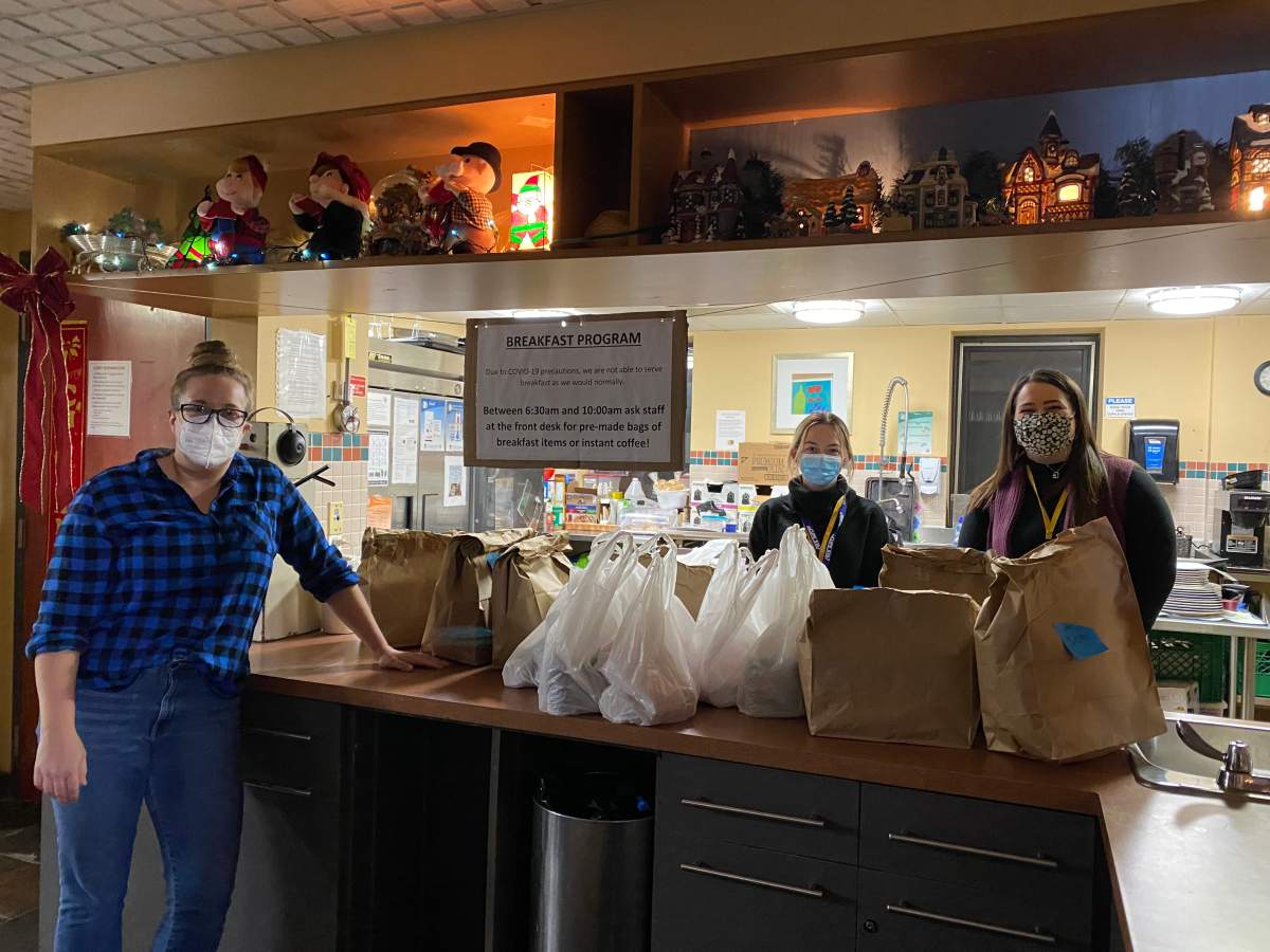 Julie Freeman (left) delivers family meals from local restaurants to Good Shepherd Family Centre in Hamilton.