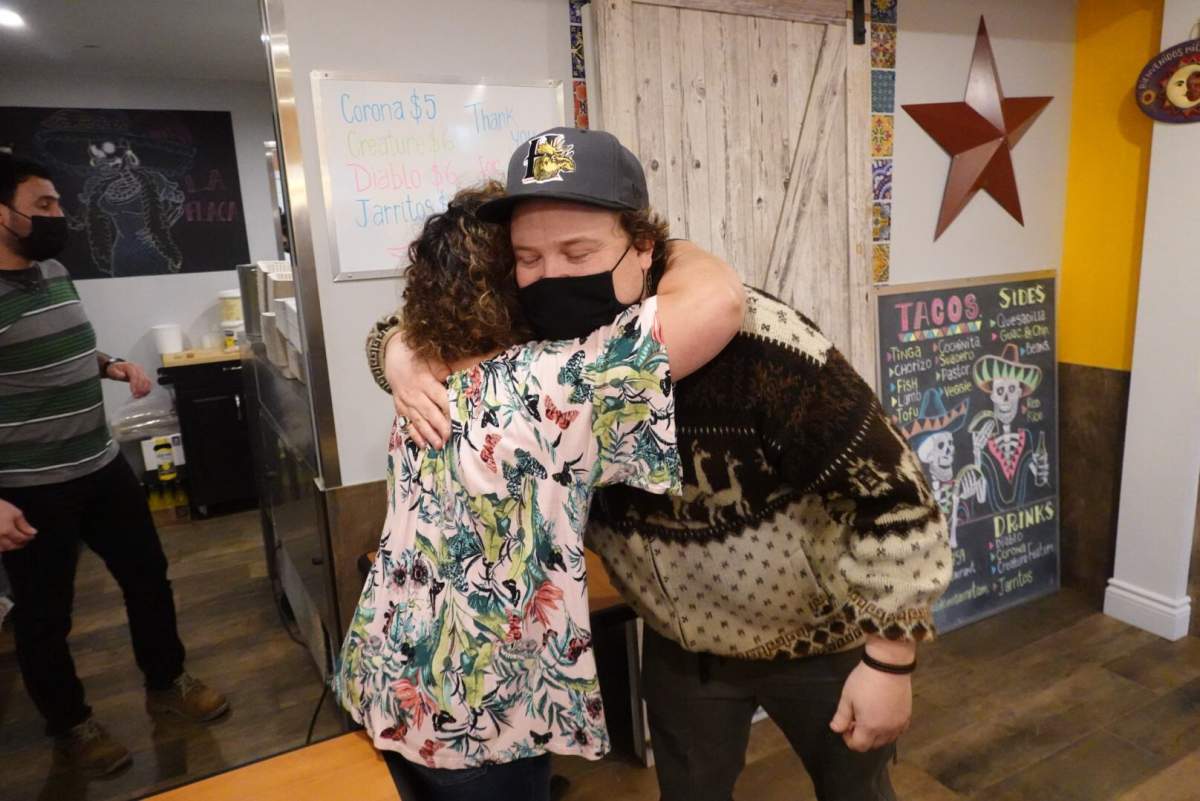 Vicky Ruiz (left) and Daniel Schloss (right) share a hug on Wednesday, Dec. 2, 2020.