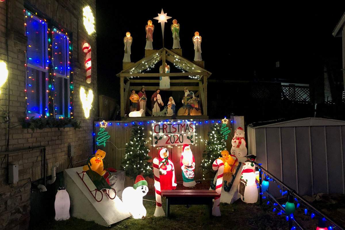 There is a manger behind a bench to allow people to take Christmas photos.