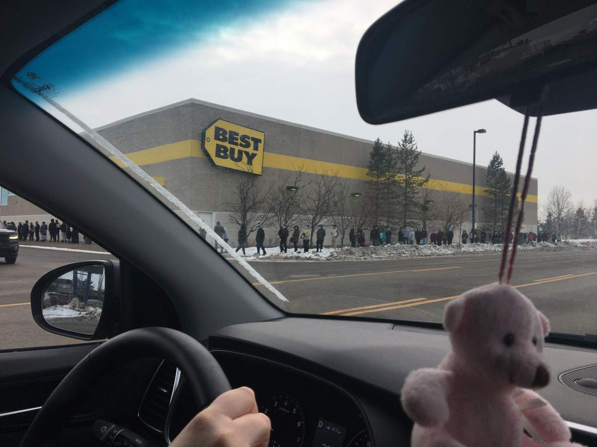 Shoppers wait outside the South Edmonton Common Best Buy on Boxing Day, Dec. 26, 2020. 
