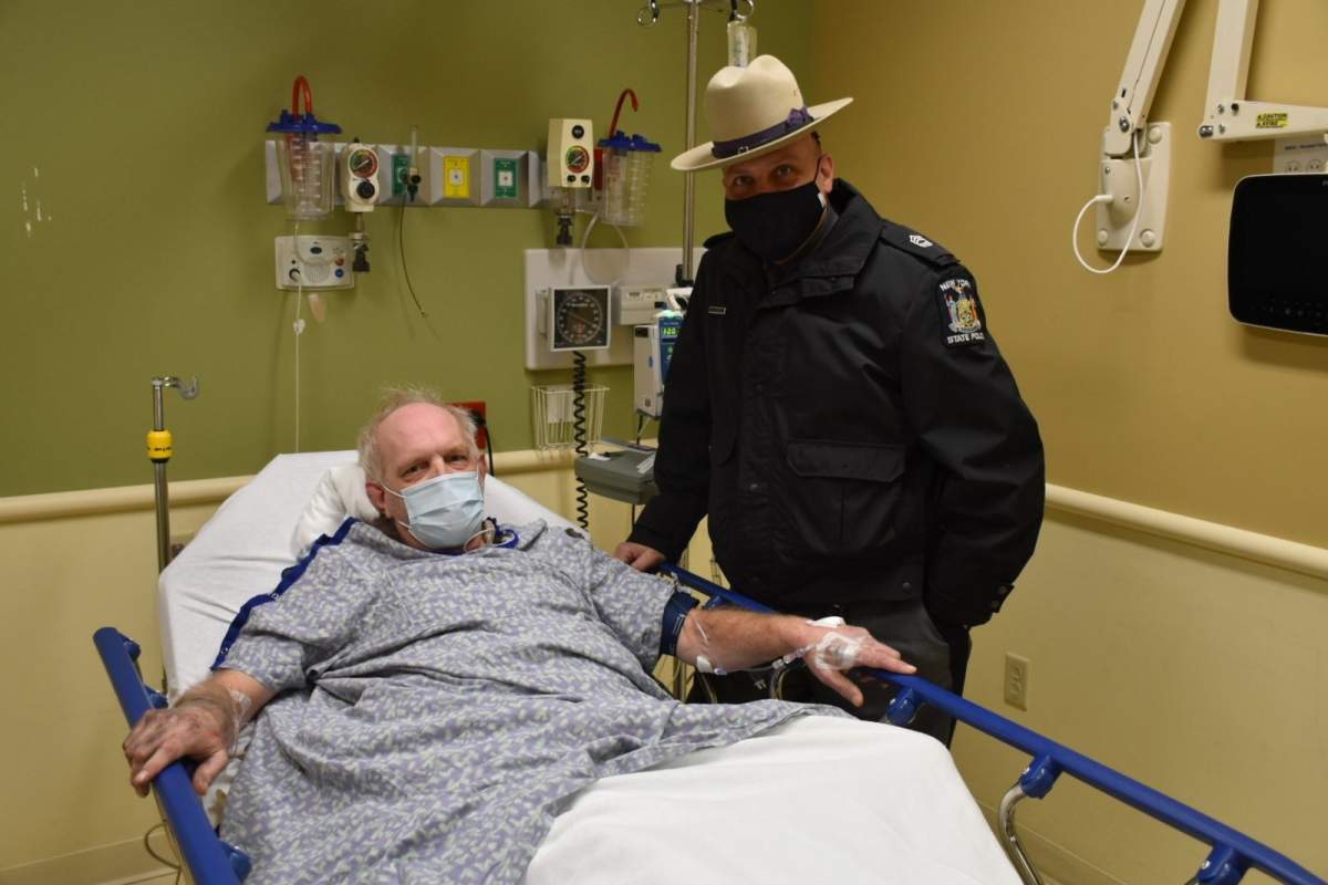 Zone Sgt. Jason Cawley, right, is shown with Kevin Kresen after he rescued him from a snowbank in Tioga County, N.Y., on Dec. 17, 2020.