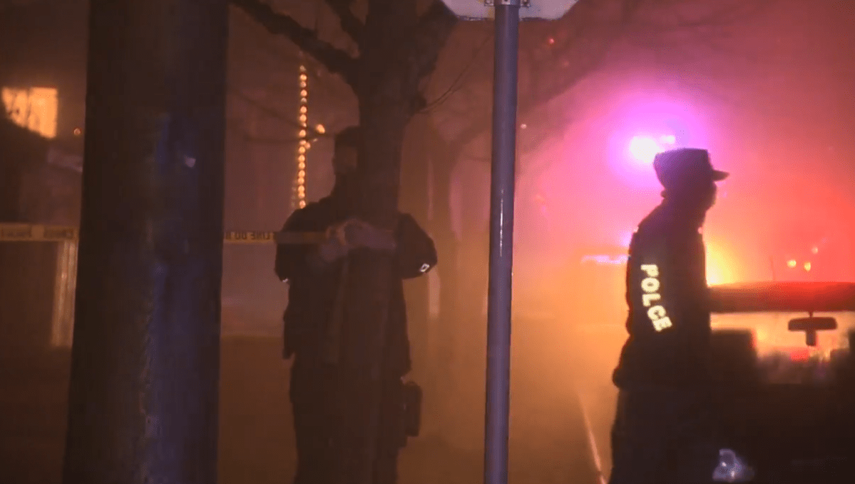 Police tape off an area of an East Vancouver neighbourhood on Friday night. 