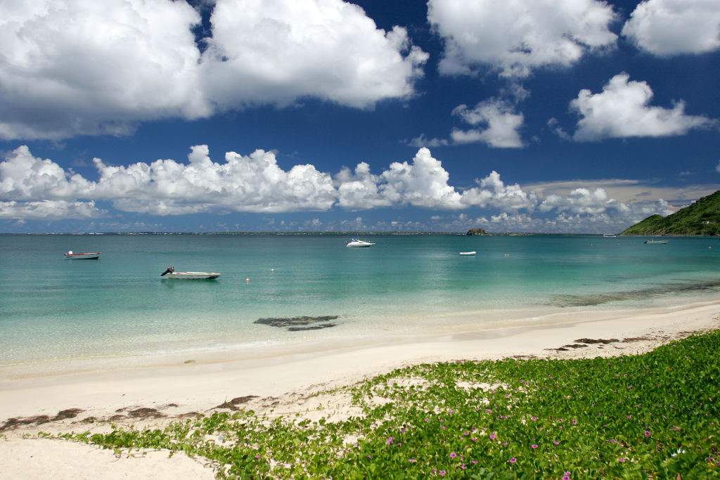 A white sand beach is shown on the French Caribbean island territory of St. Martin.