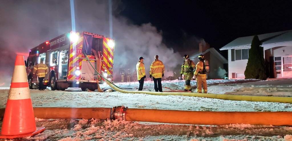 Edmonton fire crews battle a blaze in a house in the area of 93 Avenue and 72 Street Thursday, Dec. 3, 2020.