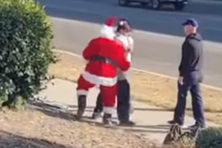 Three police officers, including one dressed as Santa, arrest a suspect in Riverside, Calif., on Dec. 10, 2020.
