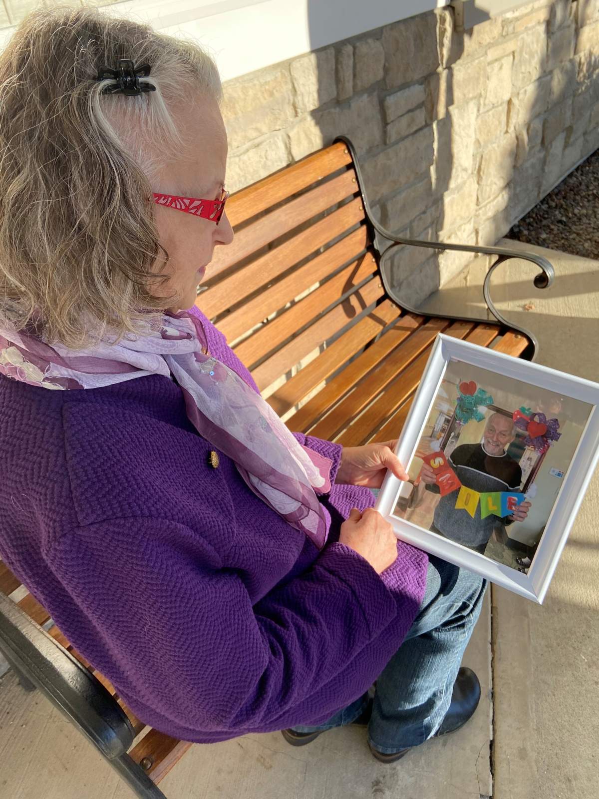 Sharon-Ann holding a photo of her husband Jim.