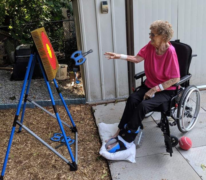 Mary Walsh throwing plastic axes in her granddaughter’s backyard in summer 2019. Tripp said her mother loved playing the game and was “pretty good.”