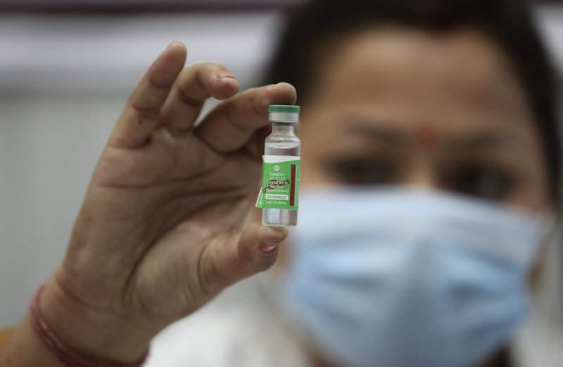 In this Saturday, Jan. 16, 2021, file photo, an Indian doctor shows a COVID-19 vaccine at a government Hospital in Jammu, India.