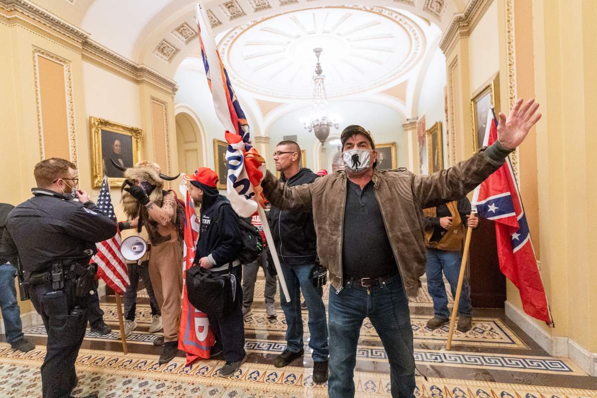 Supporters of President Donald Trump are confronted by U.S. Capitol Police officers outside the Senate Chamber inside the Capitol.