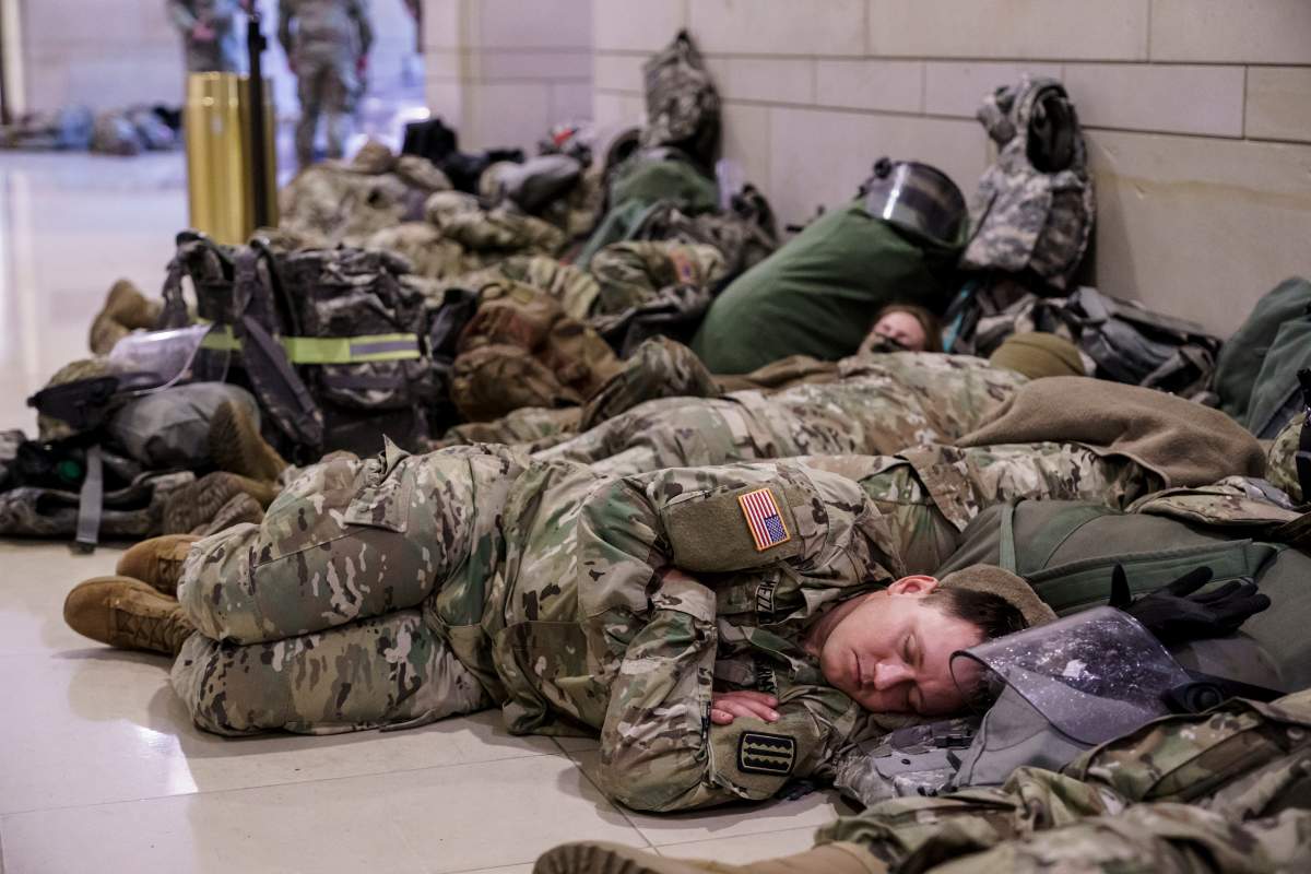Hundreds of National Guard troops hold inside the Capitol Visitor’s Center to reinforce security at the Capitol in Washington, Wednesday, Jan. 13, 2021. The House of Representatives is pursuing an article of impeachment against President Donald Trump for his role in inciting an angry mob to storm the Capitol last week. (AP Photo/J. Scott Applewhite)