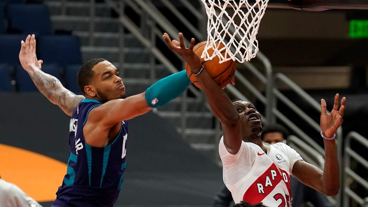 Charlotte Hornets forward P.J. Washington (25) blocks a shot by Toronto Raptors forward Chris Boucher (25, right) during the second half of an NBA basketball game Thursday, Jan. 14, 2021, in Tampa, Fla. (AP Photo/Chris O'Meara).