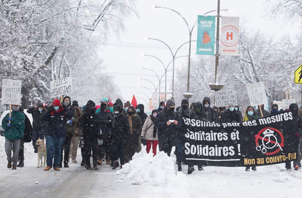 People participate in a demonstration opposing restrictions imposed by the Quebec government to help stop the spread of COVID-19 in Montreal, Saturday, January 16, 2021, as the pandemic continues in Canada and around the world. The Quebec government has imposed a lockdown and a curfew to help curb the spread of COVID-19. The curfew begins at 8 p.m until 5 a.m and lasting until February 8. 