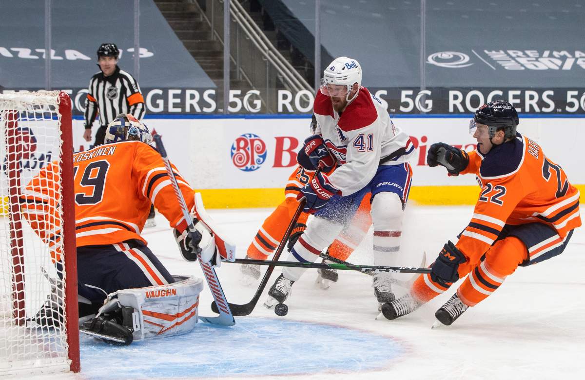 Edmonton Oilers goalie Mikko Koskinen (19) makes the save on Montreal Canadiens' Paul Byron (41) as Tyson Barrie (22) defends during third period NHL action in Edmonton on Saturday, January 16, 2021. THE CANADIAN PRESS/Jason Franson.