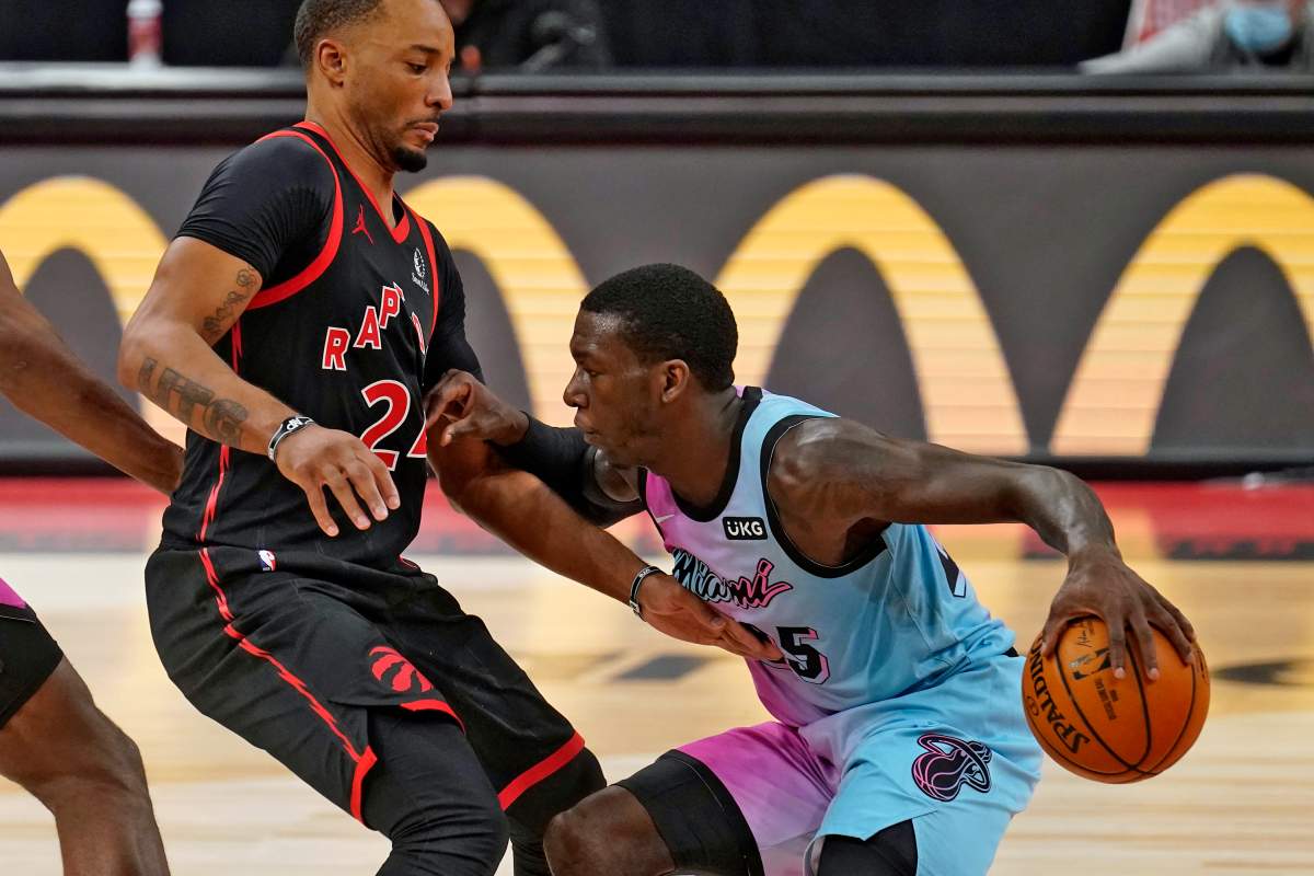 Miami Heat guard Kendrick Nunn (25) pushes off Toronto Raptors guard Norman Powell (24) as he drives up the court during the second half of an NBA basketball game Wednesday, Jan. 20, 2021, in Tampa, Fla.