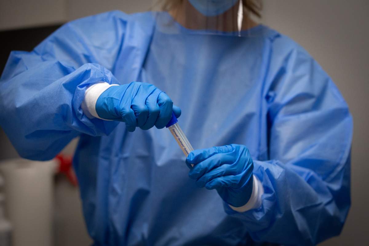 A pharmacist holds a COVID-19 test