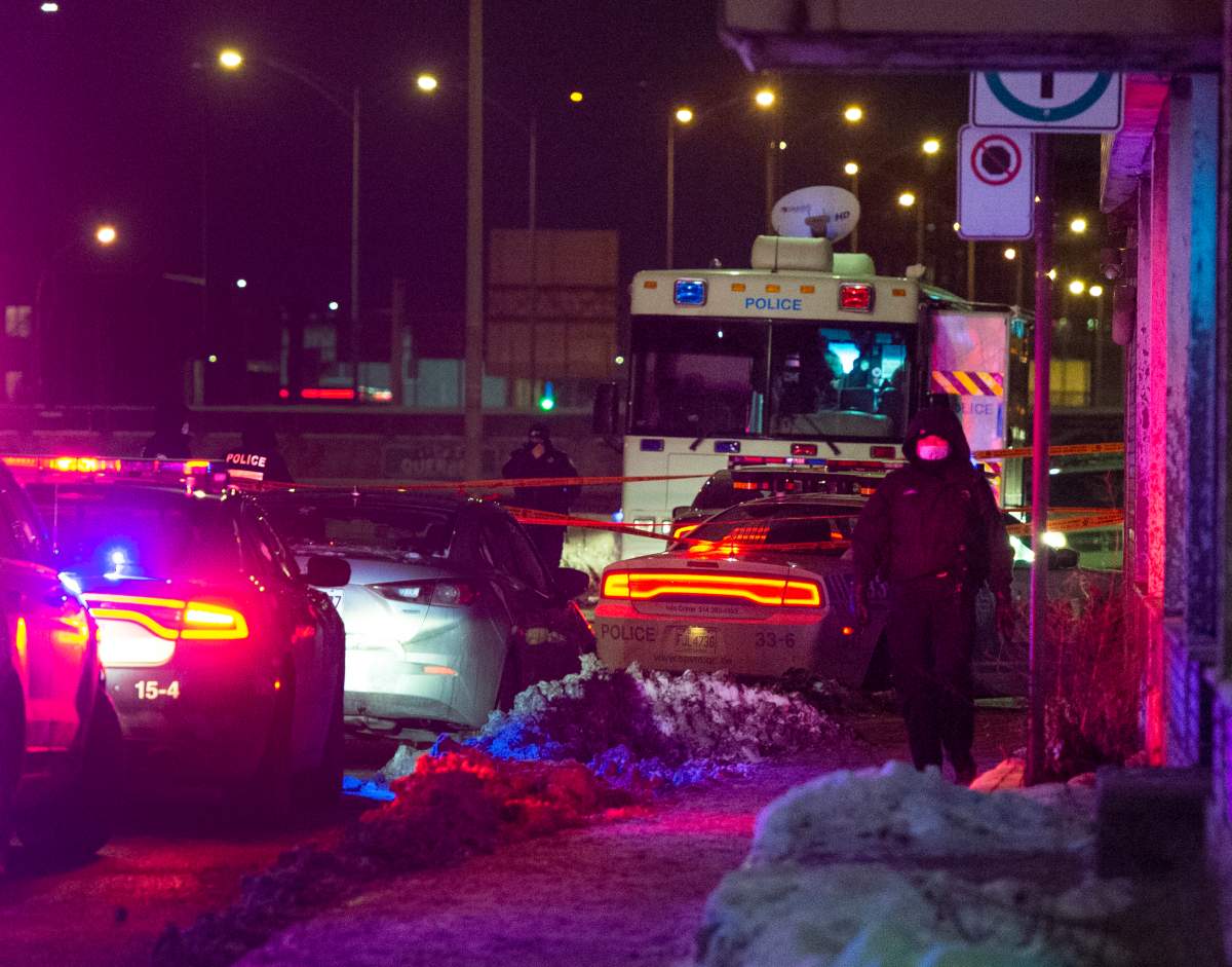 Police canvas area where an officer was shot during a traffic stop Thursday, January 28, 2021  in Montreal. 