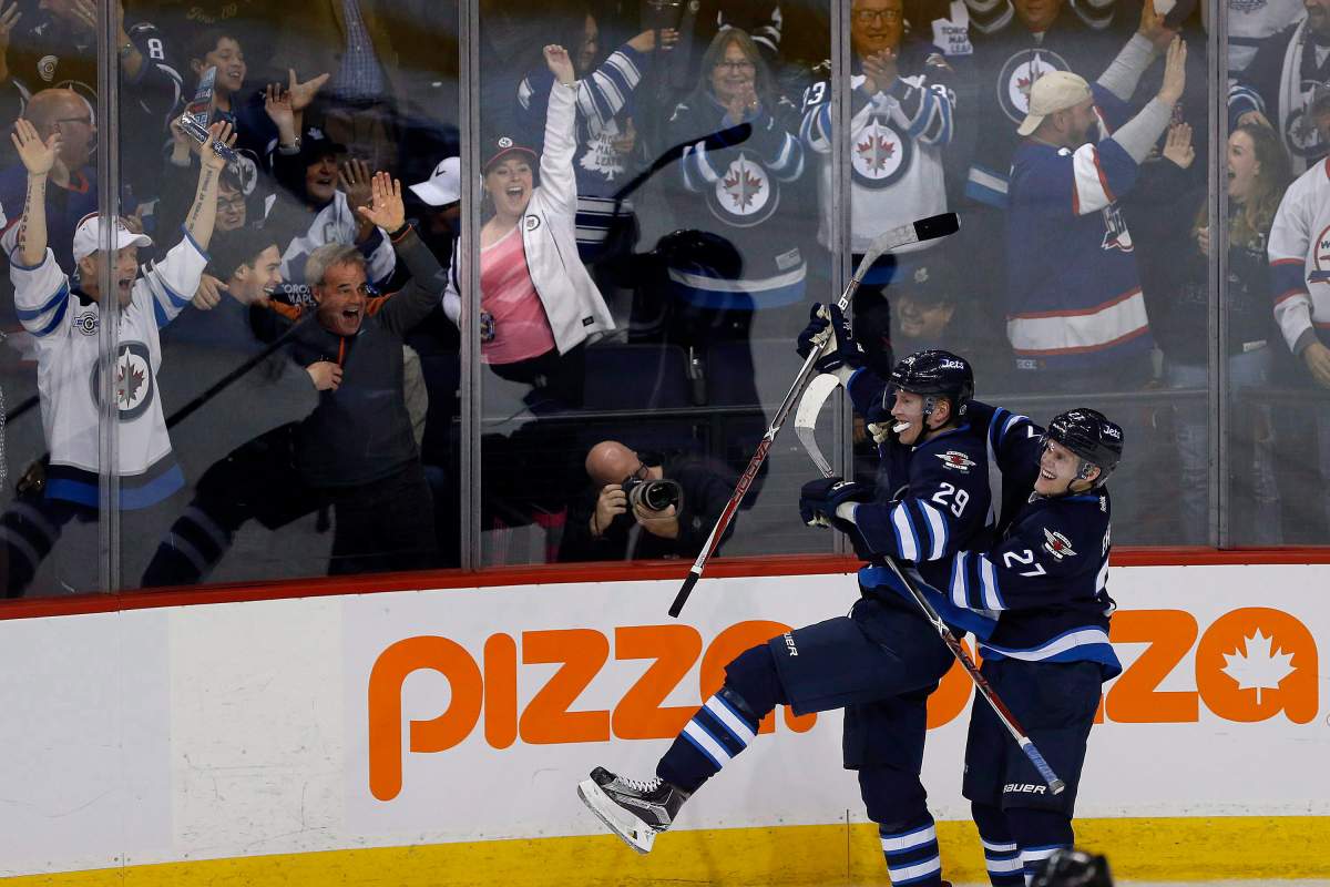 The Winnipeg Jets’ Nikolaj Ehlers (27) and Patrik Laine (29) celebrate Laine’s game-winning goal and hat trick during overtime against the Toronto Maple Leafs in NHL action in Winnipeg on Wednesday, Oct. 19, 2016.