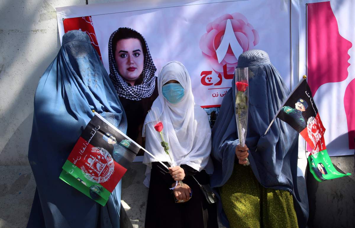 Civil society activists gathered the less fortunate to mark International Women's Day in Kabul, Afghanistan, Sunday, March 8, 2020. 