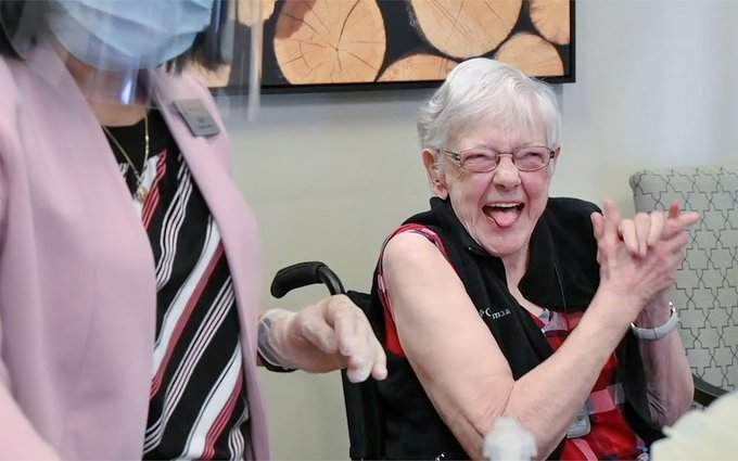 Helen, 83, shows her joy at being vaccinated at her continuing care facility in the Calgary zone.