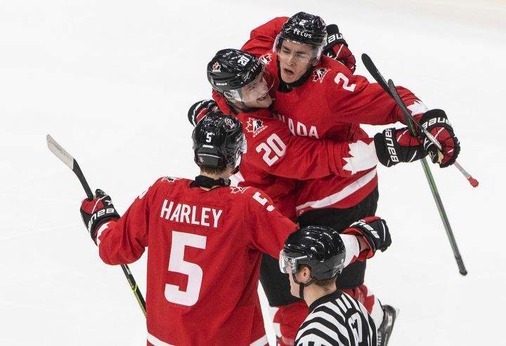 Canada defenseman Braden Schneider (2) celebrates his goal with teammates Thomas Harley (5) and Dawson Mercer (20) against Russia during second period IIHF World Junior Hockey Championship action in Edmonton on Monday, January 4, 2021. 