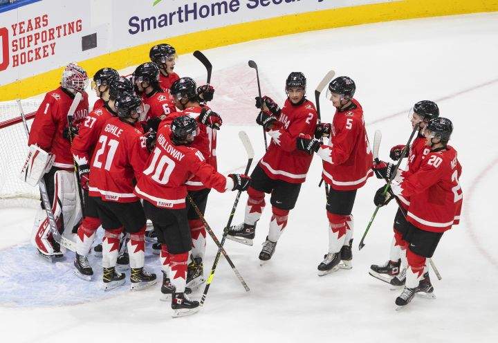 Canada celebrates the win over Russia at the end of the third period IIHF World Junior Hockey Championship action in Edmonton on Monday, January 4, 2021.