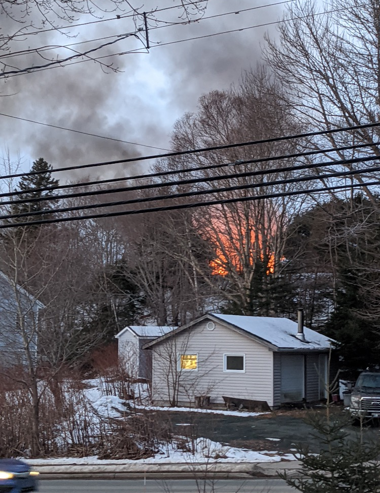Fire and smoke are seen as an abandoned home in Fall River, N.S., burned on Wednesday.