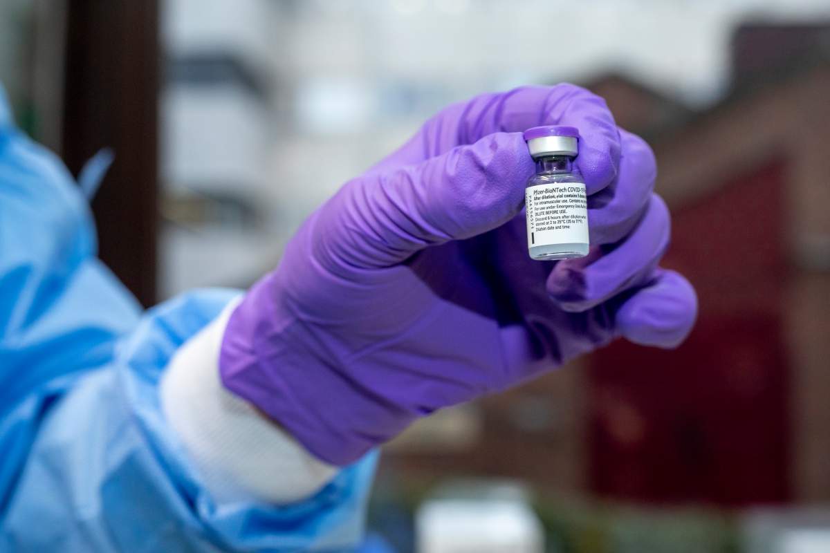 Illustration shows a hand with a glove holding a dose of the vaccine at the vaccination of the staff members of the UZ Brussels University Hospital with the COVID-19 vaccine of Pfizer-BioNTech, in Jette, Brussels, Tuesday, Jan. 19, 2021.