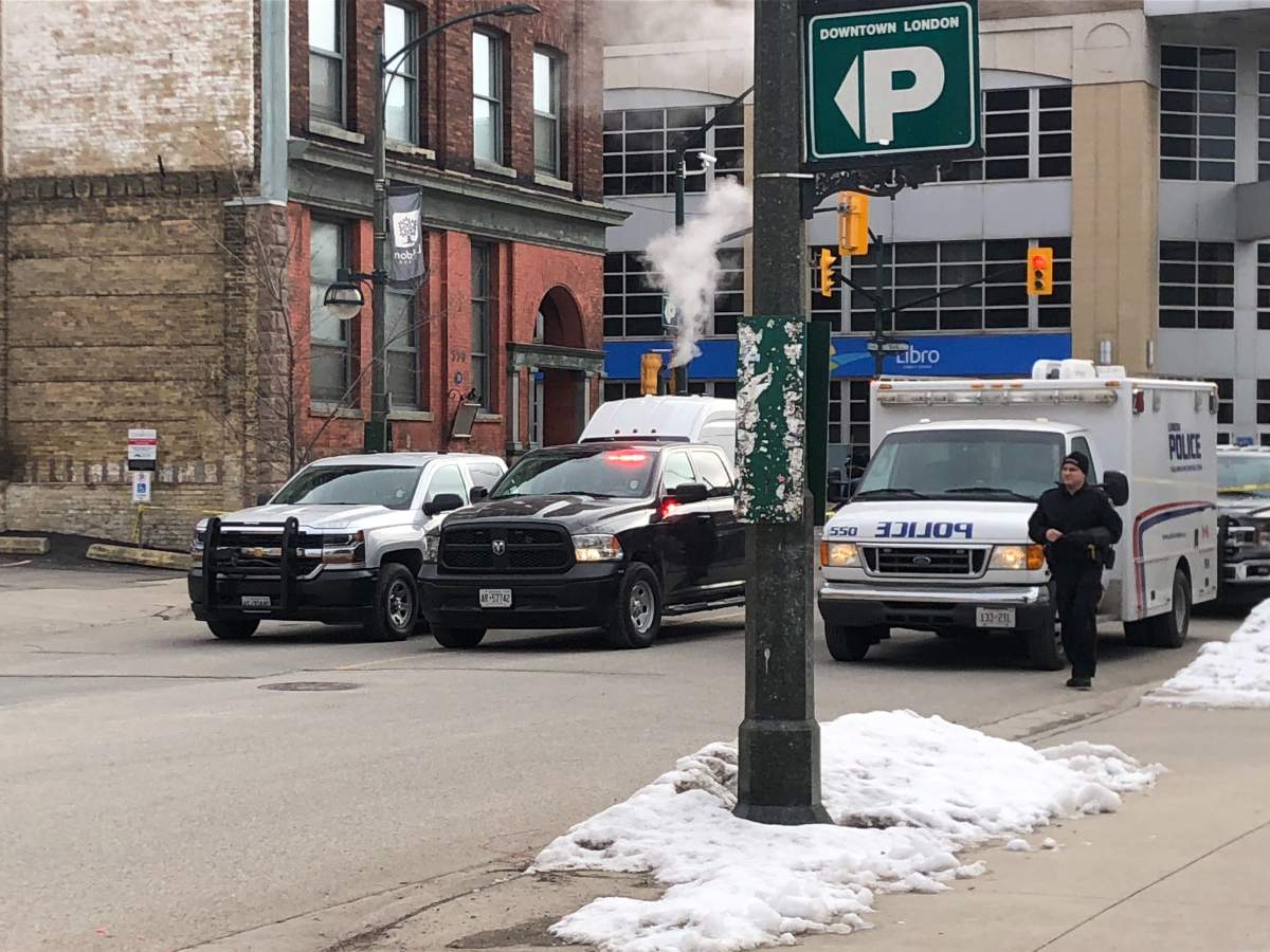 Officers with the traffic management unit investigate a crash in downtown London on Friday morning.