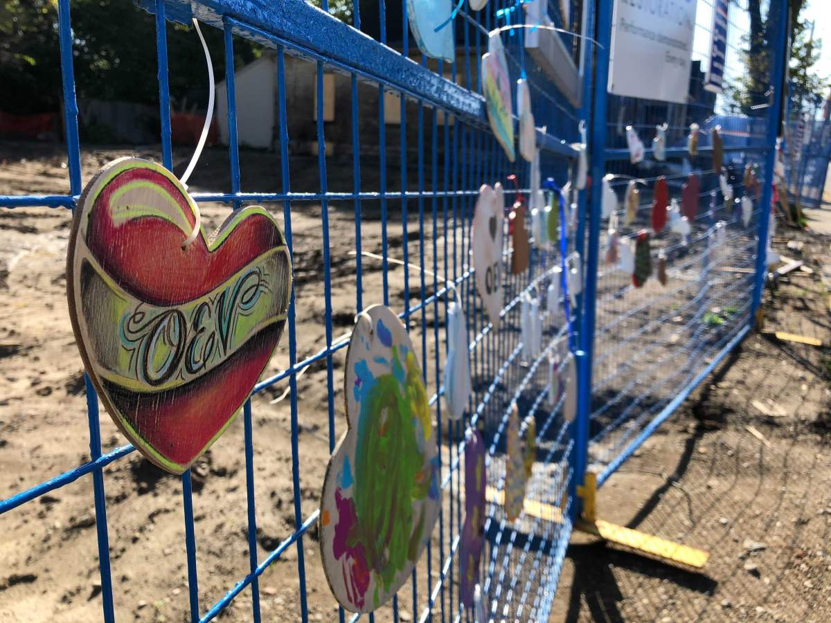 A memorial is set up outside the site of 450 Woodman Ave. about two months after a 2019 car crash led to a house-levelling explosion.