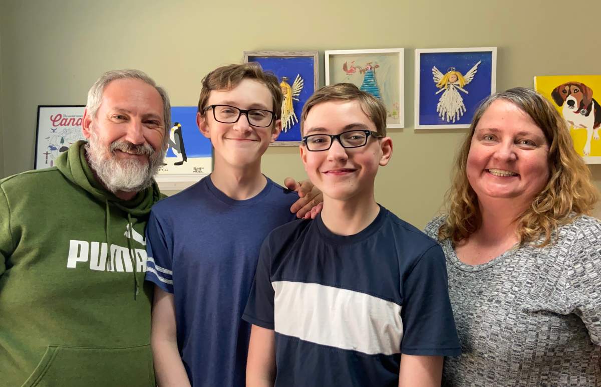 Family poses for photo as part of a kids social media story.