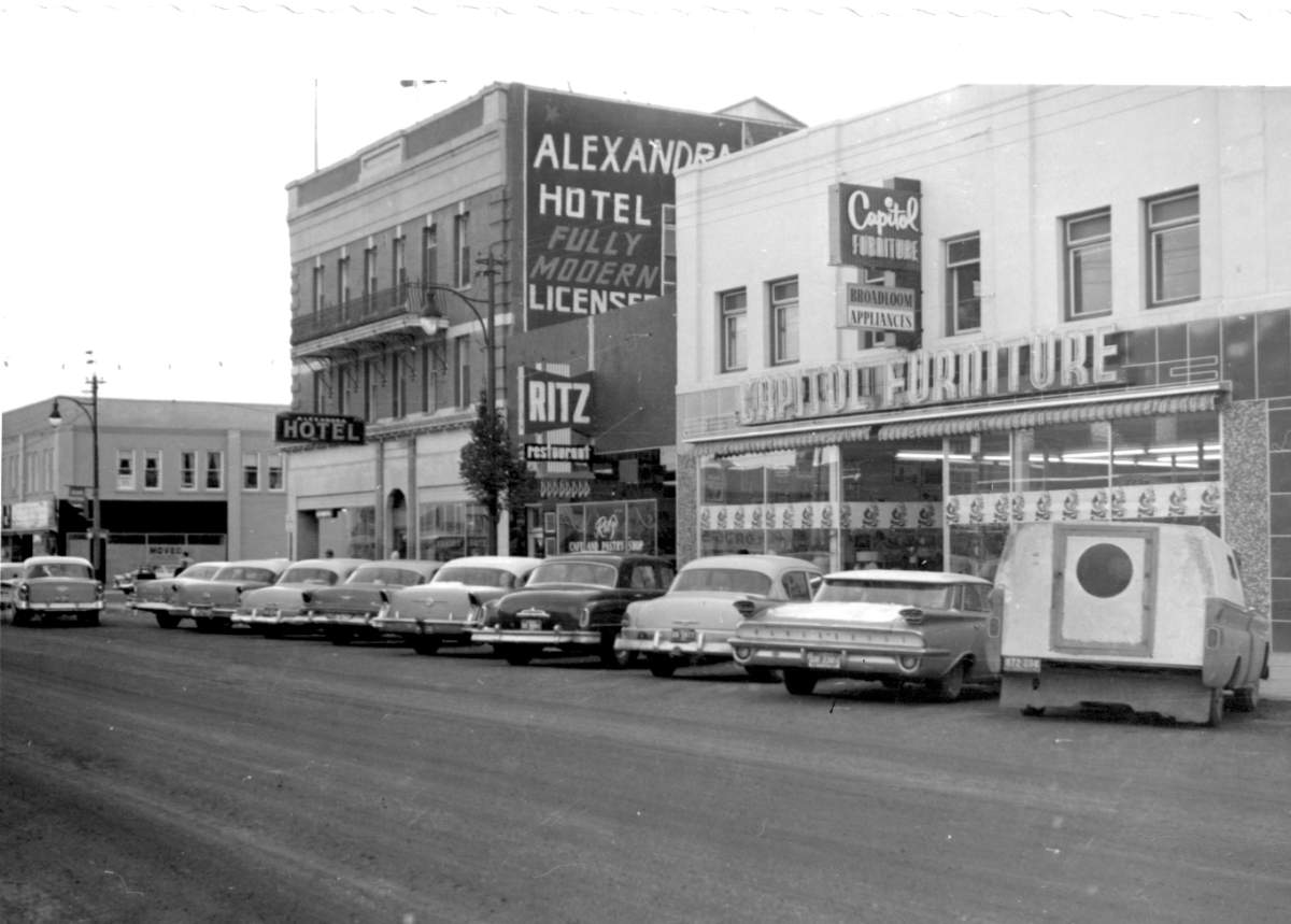 View of the west side of the 300 block of 5 Street South. Visible are, from left to right: Alexandra Hotel, Ritz Cafe, Captiol Furniture. Taken Dec. 5, 1960.