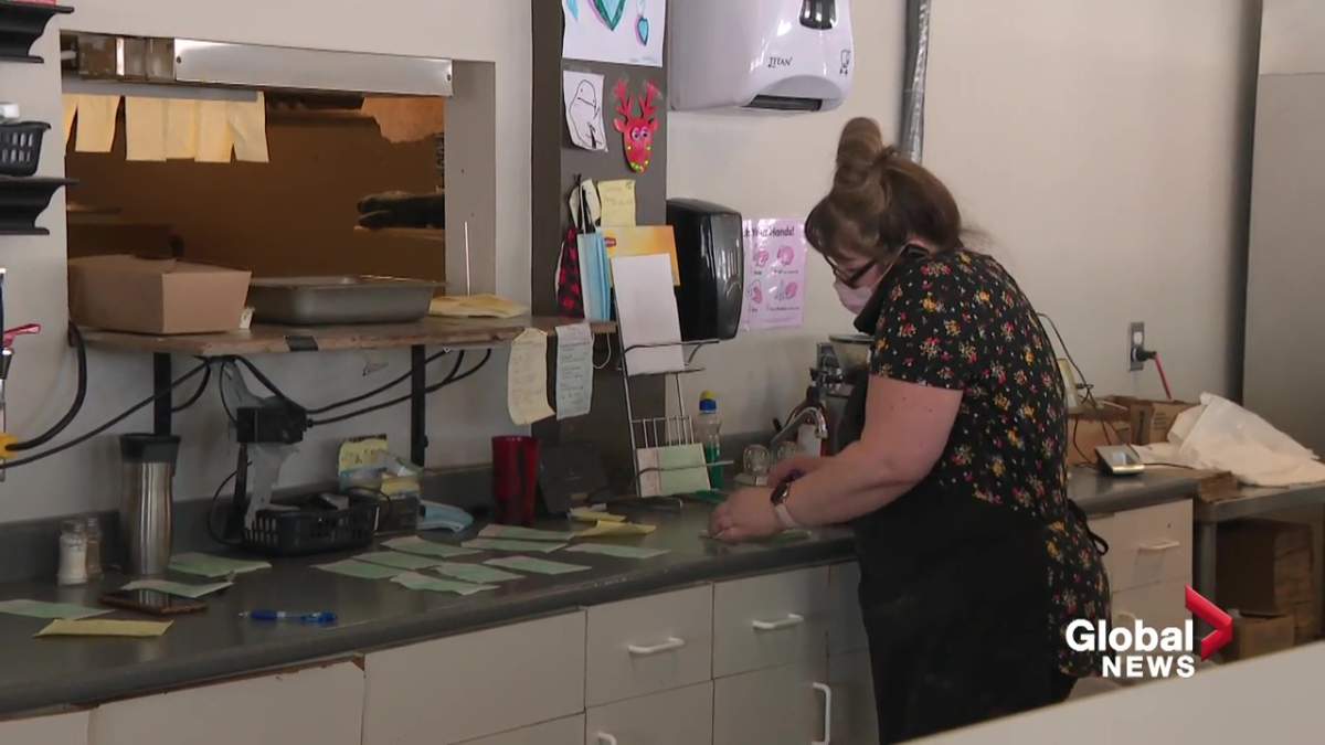 Saskitoba Diner owner Candy Galay taking an order over the phone at her business in Nisku, Alta. on January 28, 2021.