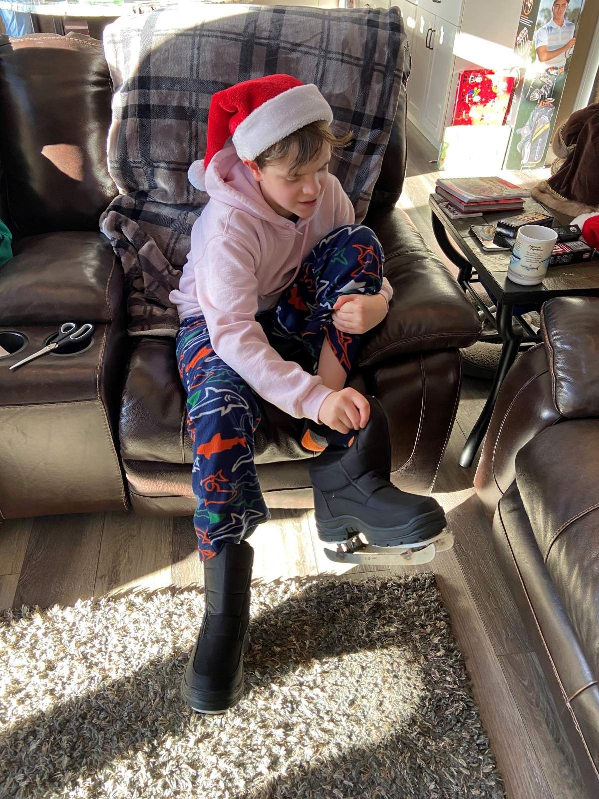 Zander tries on his new skates Christmas morning.