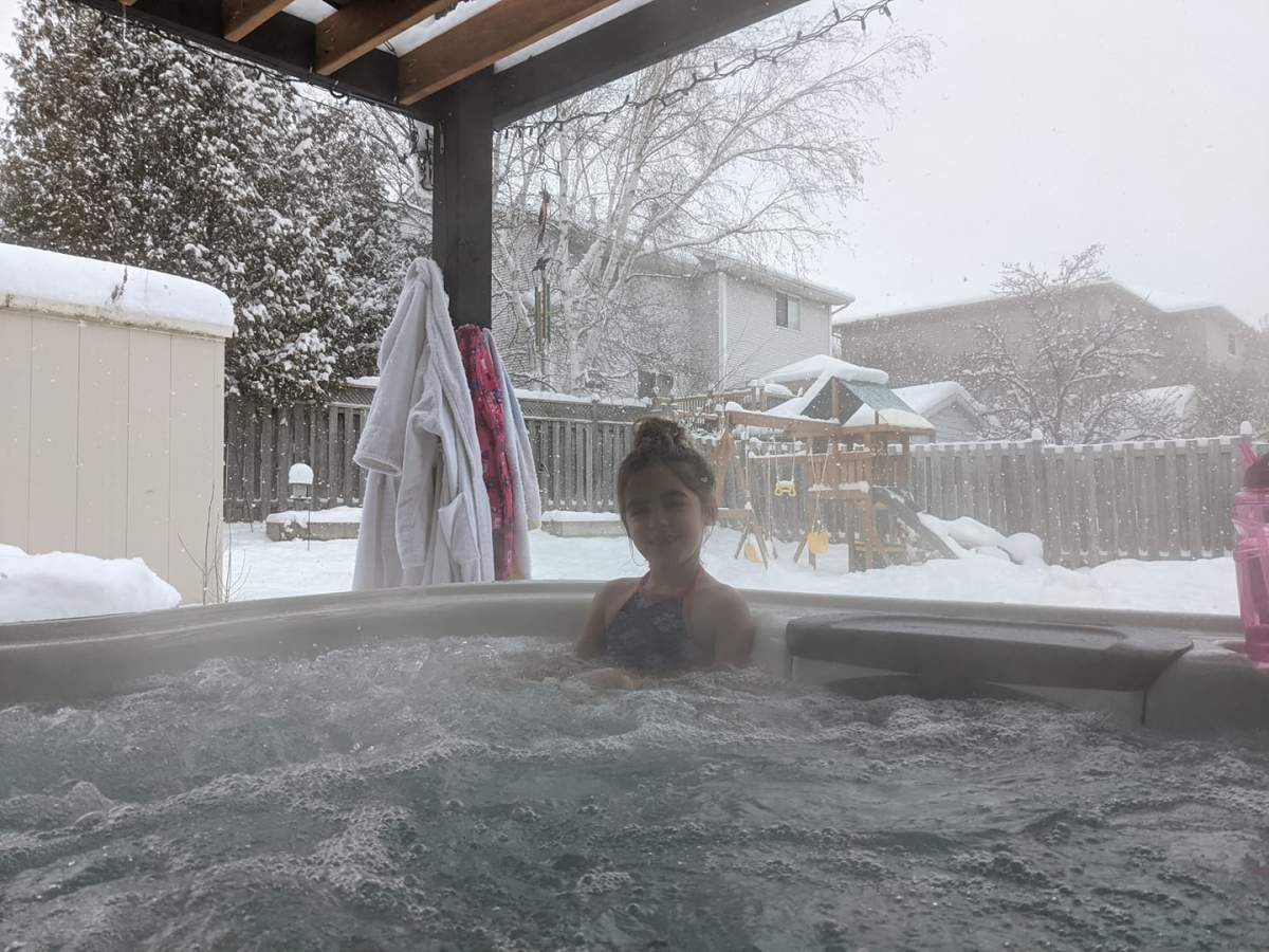 Carrie Nissen and her daughter Audrey enjoying the hot tub after a heavy snowfall in east London.