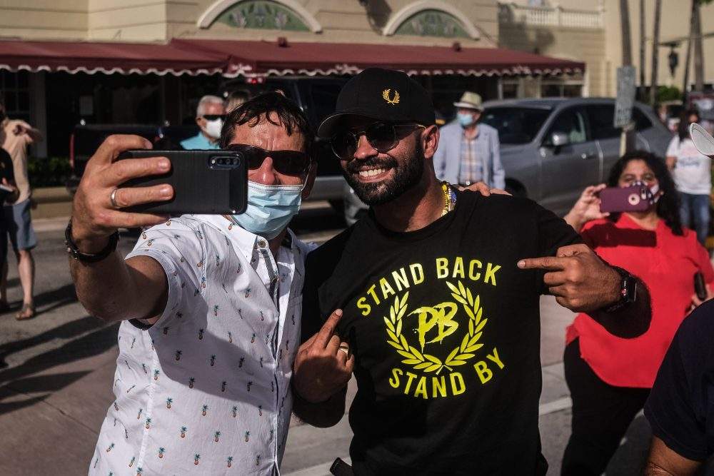 Enrique Tarrio, leader of the far-right group Proud Boys, poses for a photo as demonstrators participate in ‘Latinos for Trump’ demonstration, a parade in support of US President Donald J. Trump, at Tamiami Park in Miami, Fla., on Oct. 18, 2020.