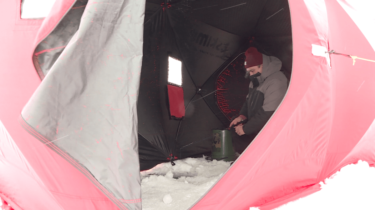 Leon Belandiuk fishing inside his tent at the FAAM derby on Sunday at Lake Winnipeg.